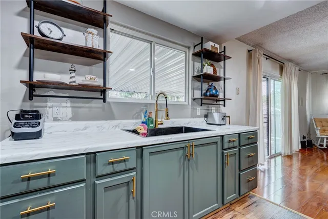 a kitchen with stainless steel appliances a sink stove and cabinets
