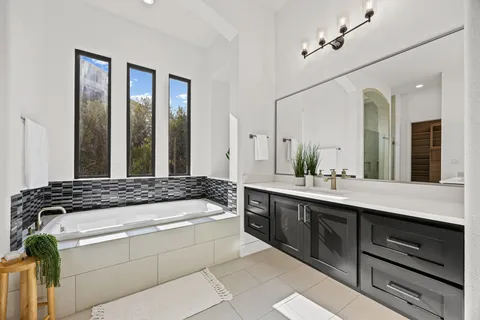 a spacious bathroom with a granite countertop sink mirror and double