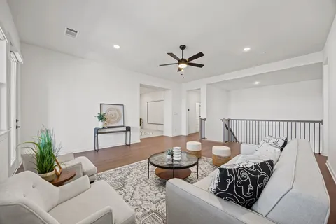 a living room with furniture and wooden floor
