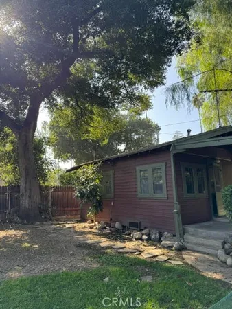 a view of a backyard with table and chairs and wooden fence