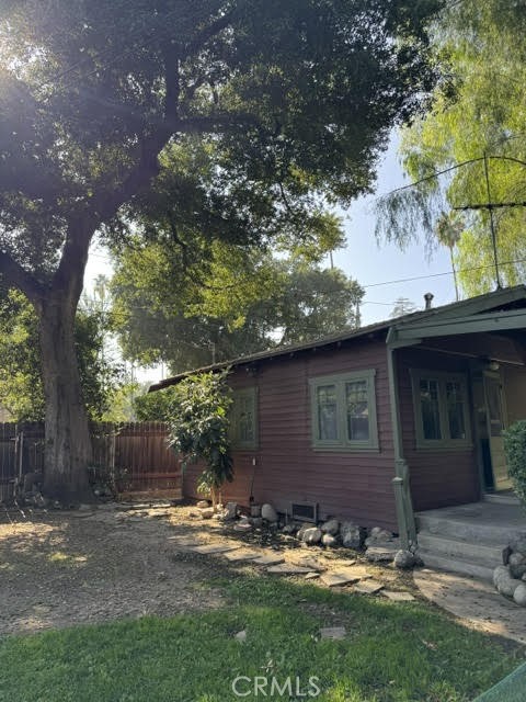 4482 4th Street Riverside, CA 92501 - Photo 3 of 7 a view of a backyard with table and chairs and wooden fence