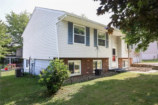 a view of a house with a yard and front view of a house