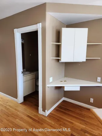 a view of cabinets and wooden floor