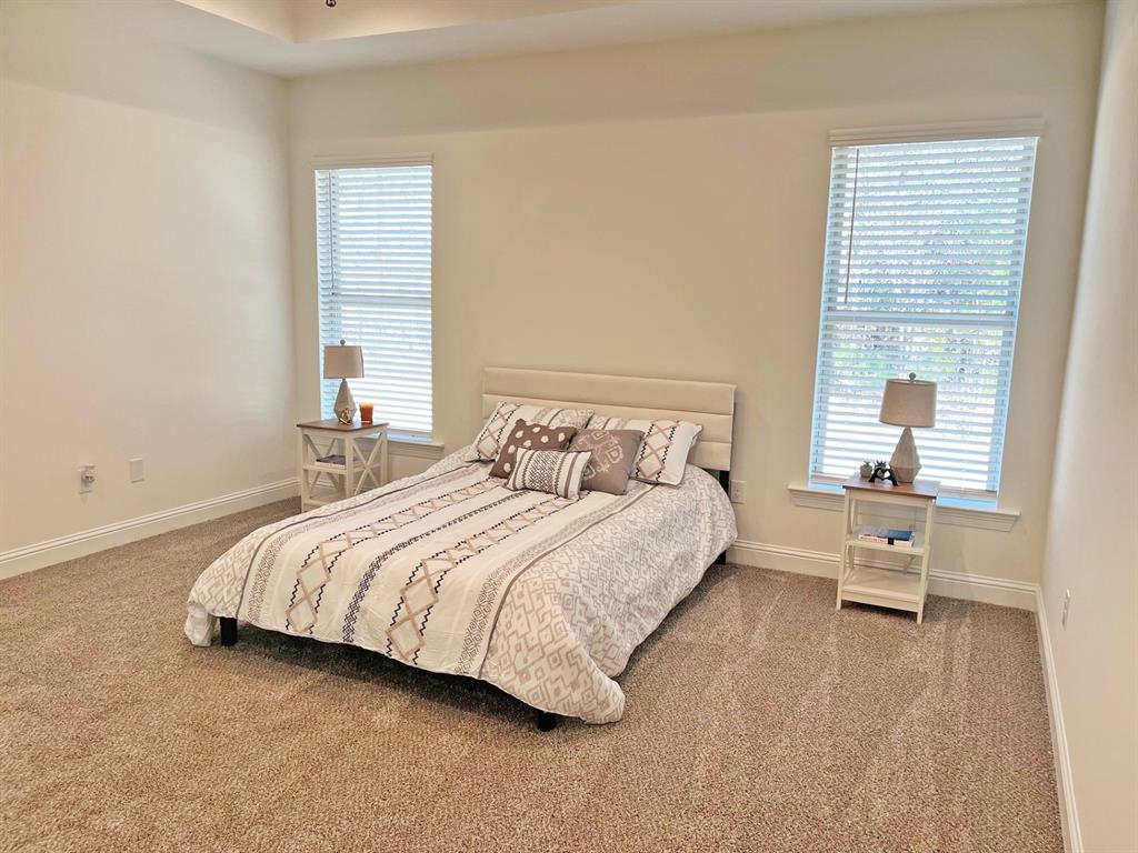 159 Lessie Drive Stonewall, LA 71078 - Photo 18 of 26 a bedroom with a bed and wooden floor