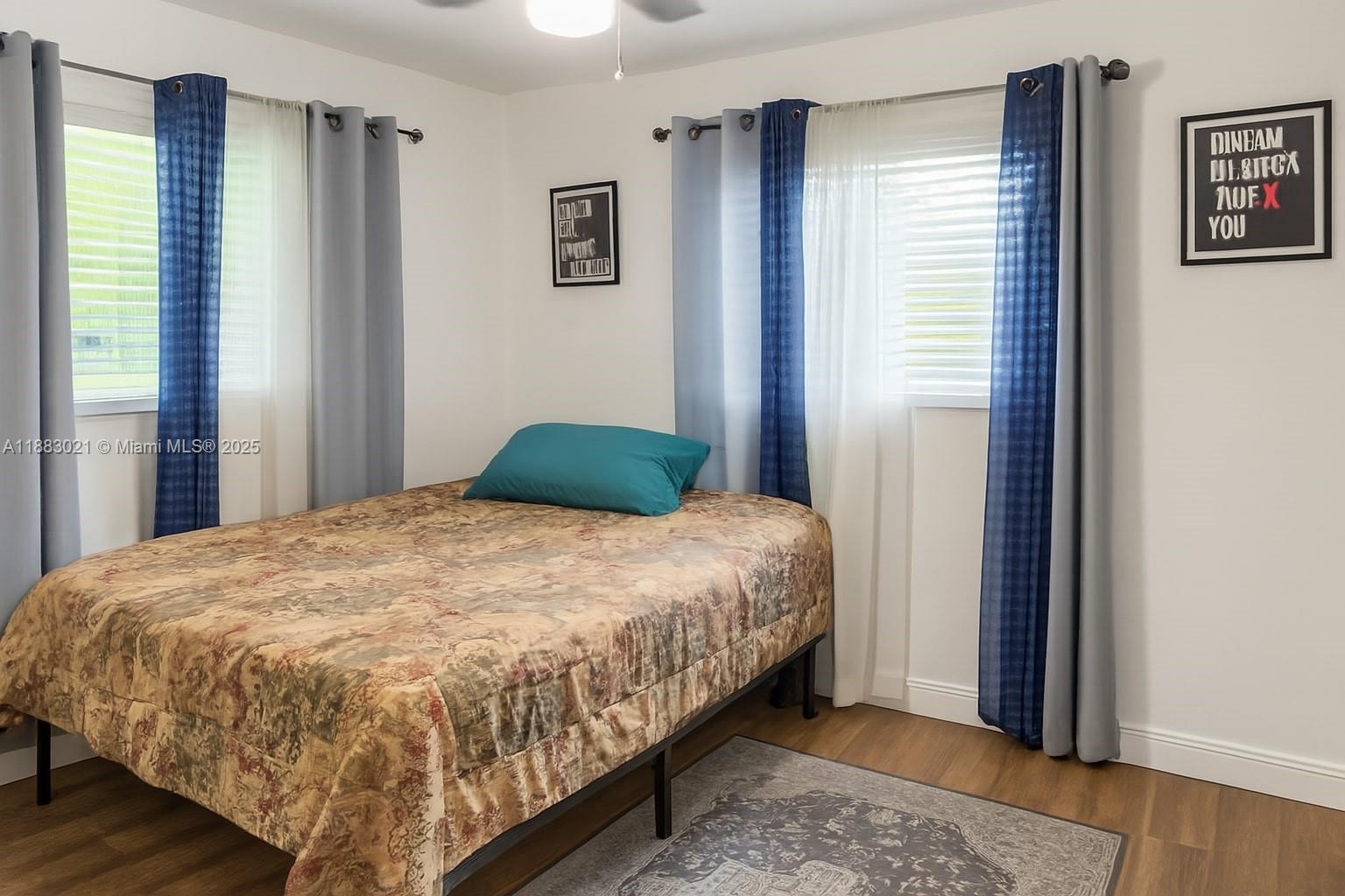 3770 Northwest 8th Place Lauderhill, FL 33311 - Photo 12 of 31 a bed sitting in a bedroom next to a window