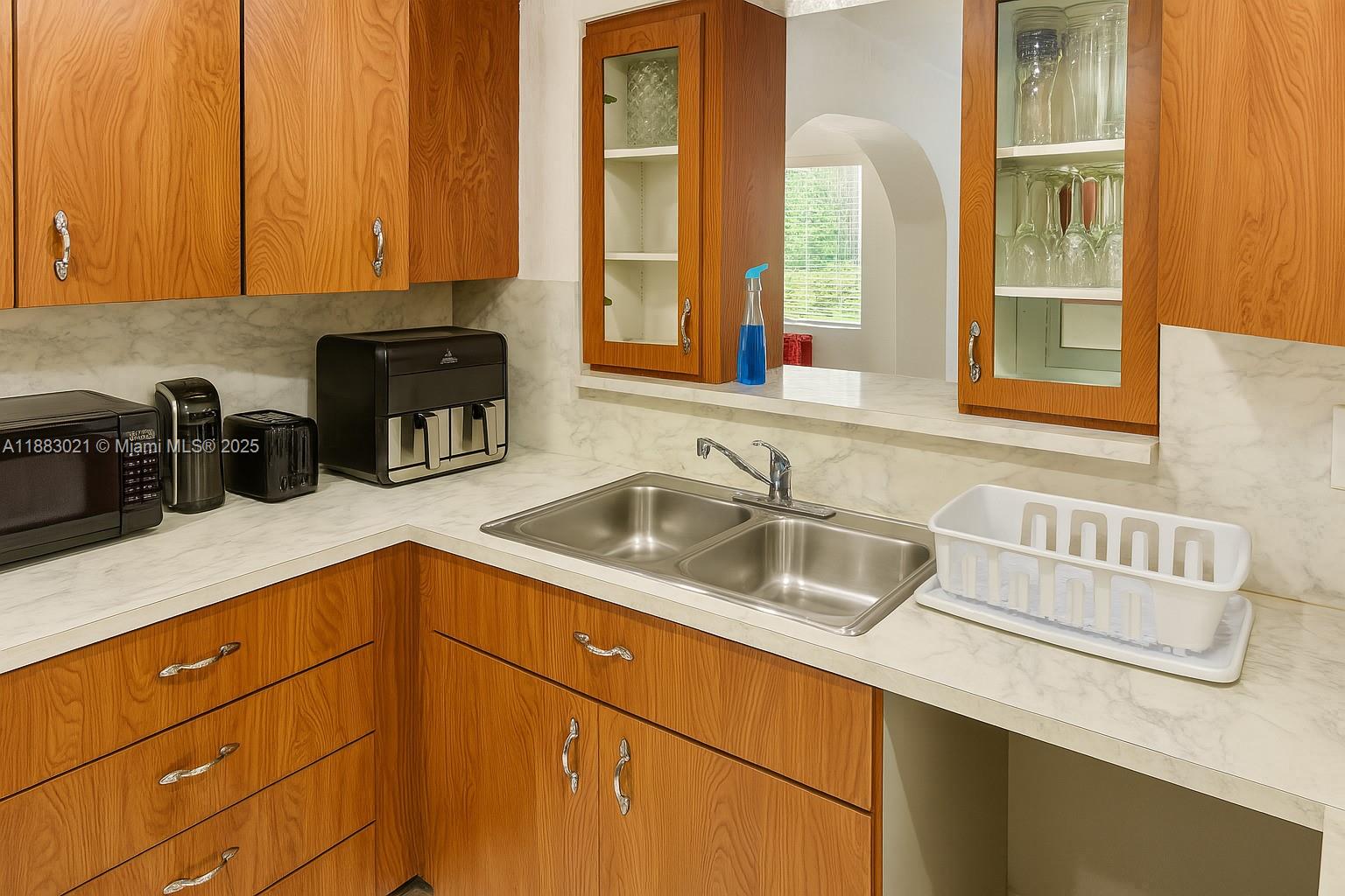 3770 Northwest 8th Place Lauderhill, FL 33311 - Photo 15 of 31 a kitchen with a sink and cabinets