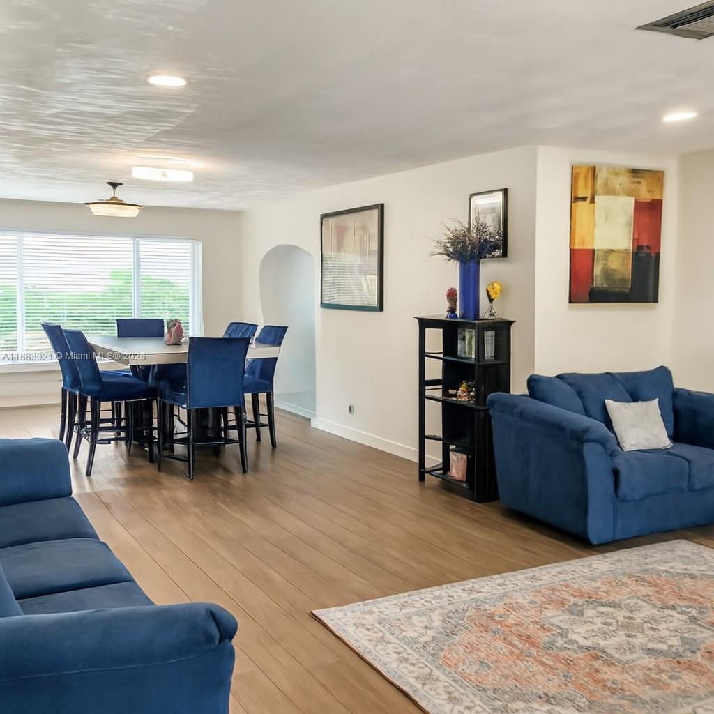 3770 Northwest 8th Place Lauderhill, FL 33311 - Photo 16 of 31 a living room with furniture wooden floor and dining table