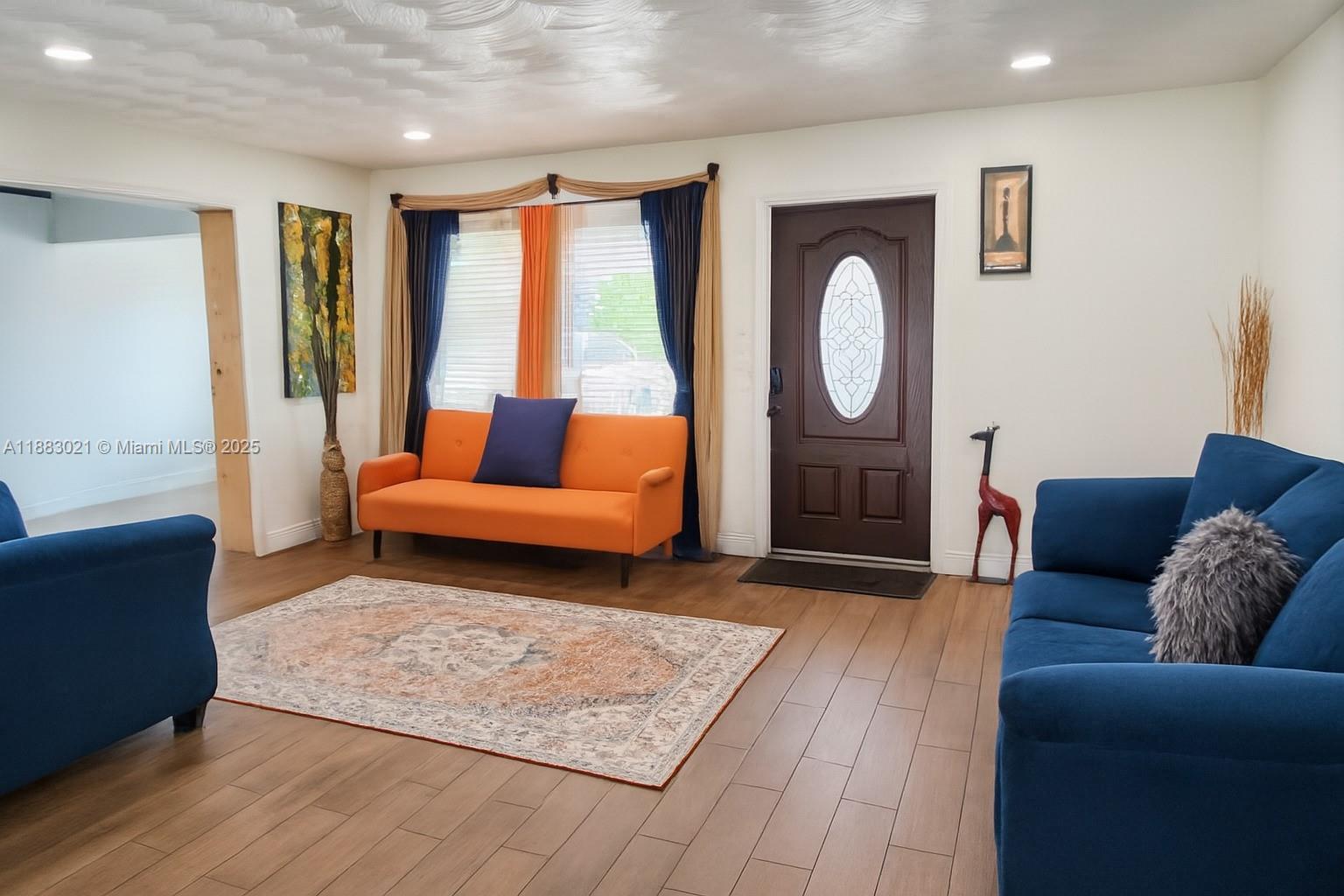3770 Northwest 8th Place Lauderhill, FL 33311 - Photo 2 of 31 a living room with furniture and a rug
