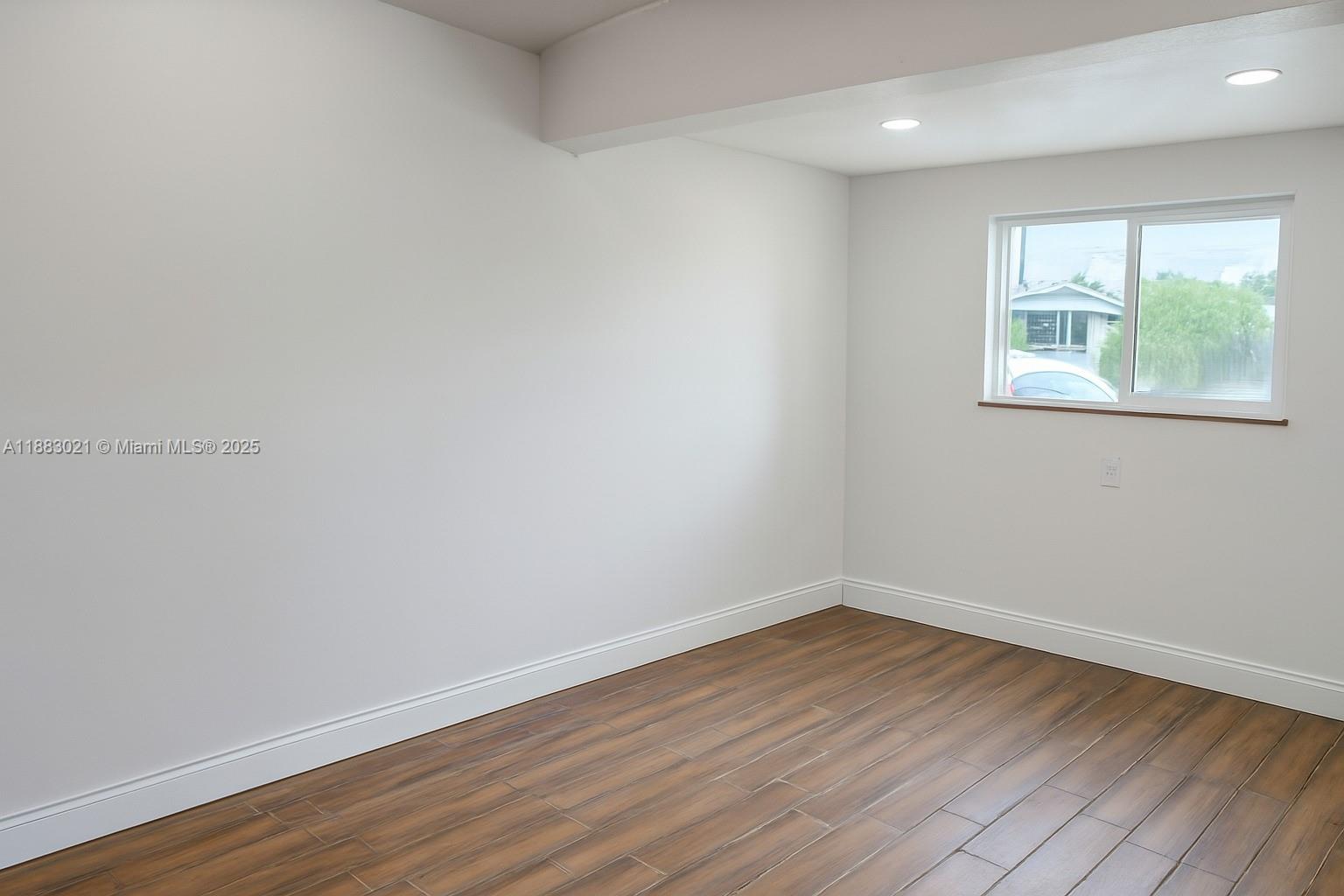 3770 Northwest 8th Place Lauderhill, FL 33311 - Photo 30 of 31 wooden floor in an empty room with a window