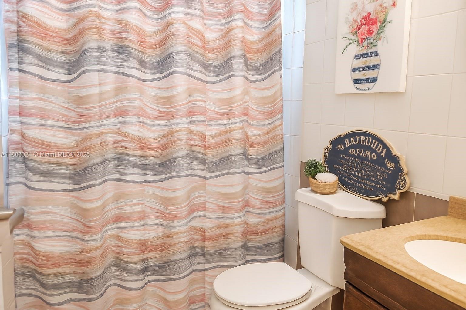 3770 Northwest 8th Place Lauderhill, FL 33311 - Photo 10 of 31 a bathroom with a toilet and a sink