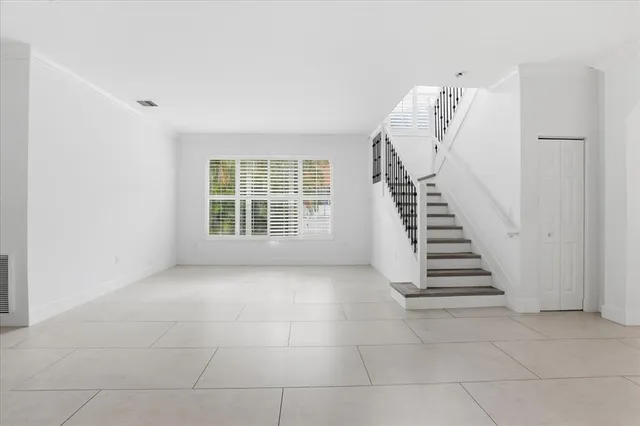 a large white room with windows and chandelier