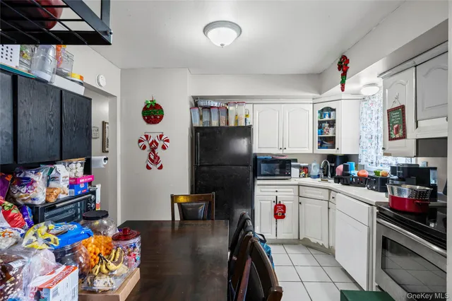 a kitchen that has a lot of cabinets a washer and dryer