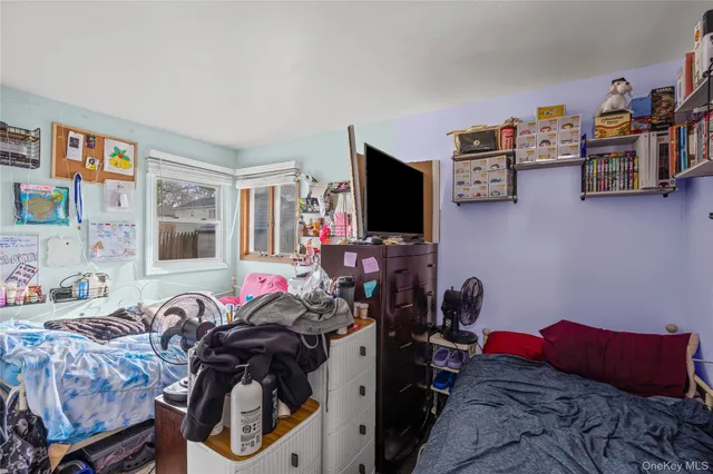 a bedroom with furniture and a flat screen tv