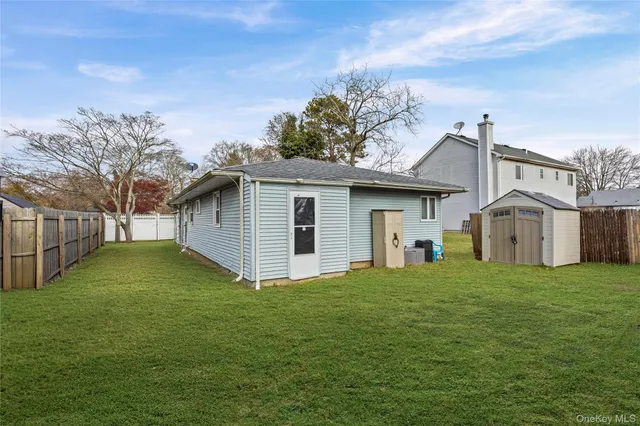 a view of a yard in front of a house with large trees