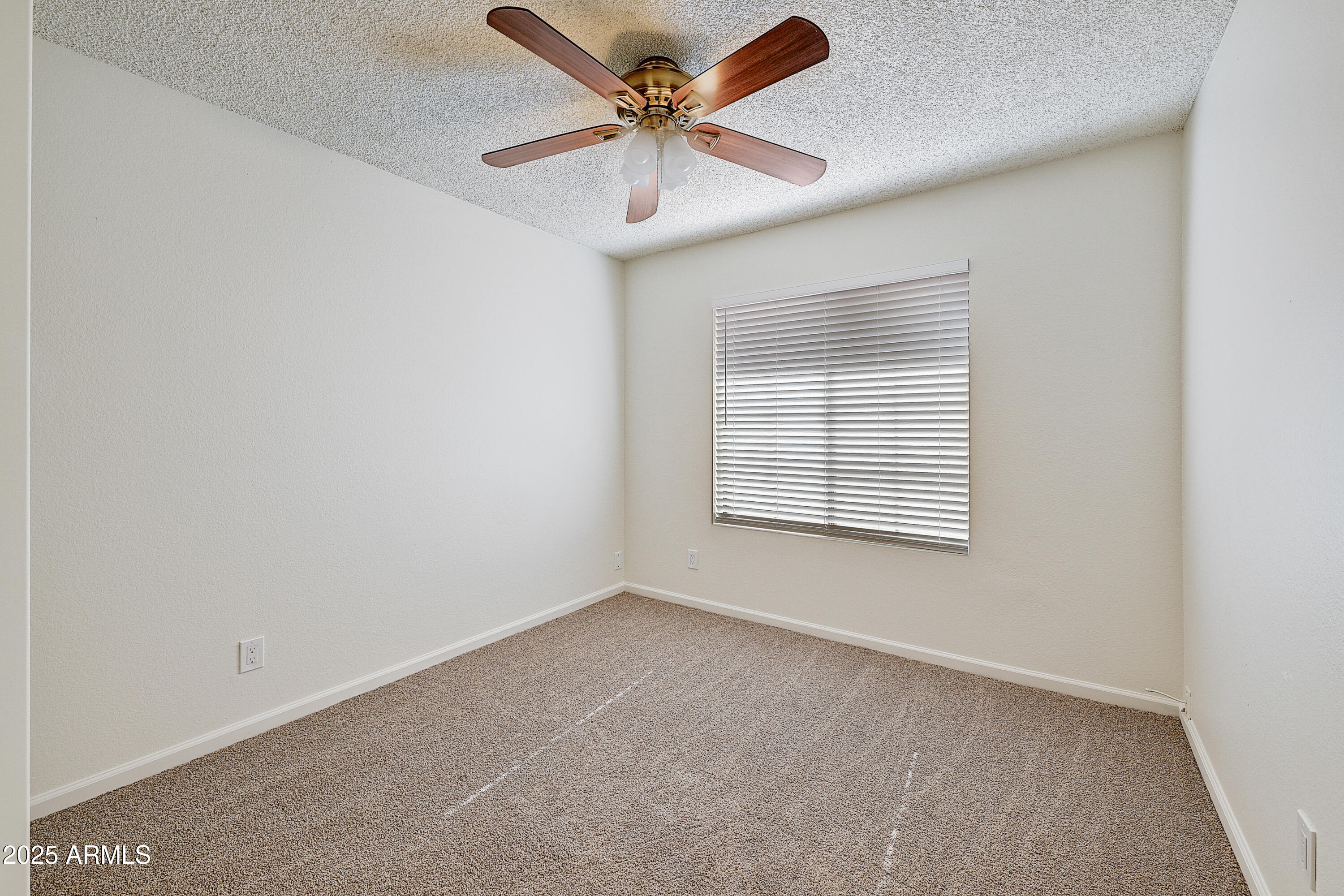 925 North College Avenue, Unit E217 Tempe, AZ 85288 - Photo 14 of 32 an empty room with windows and fan