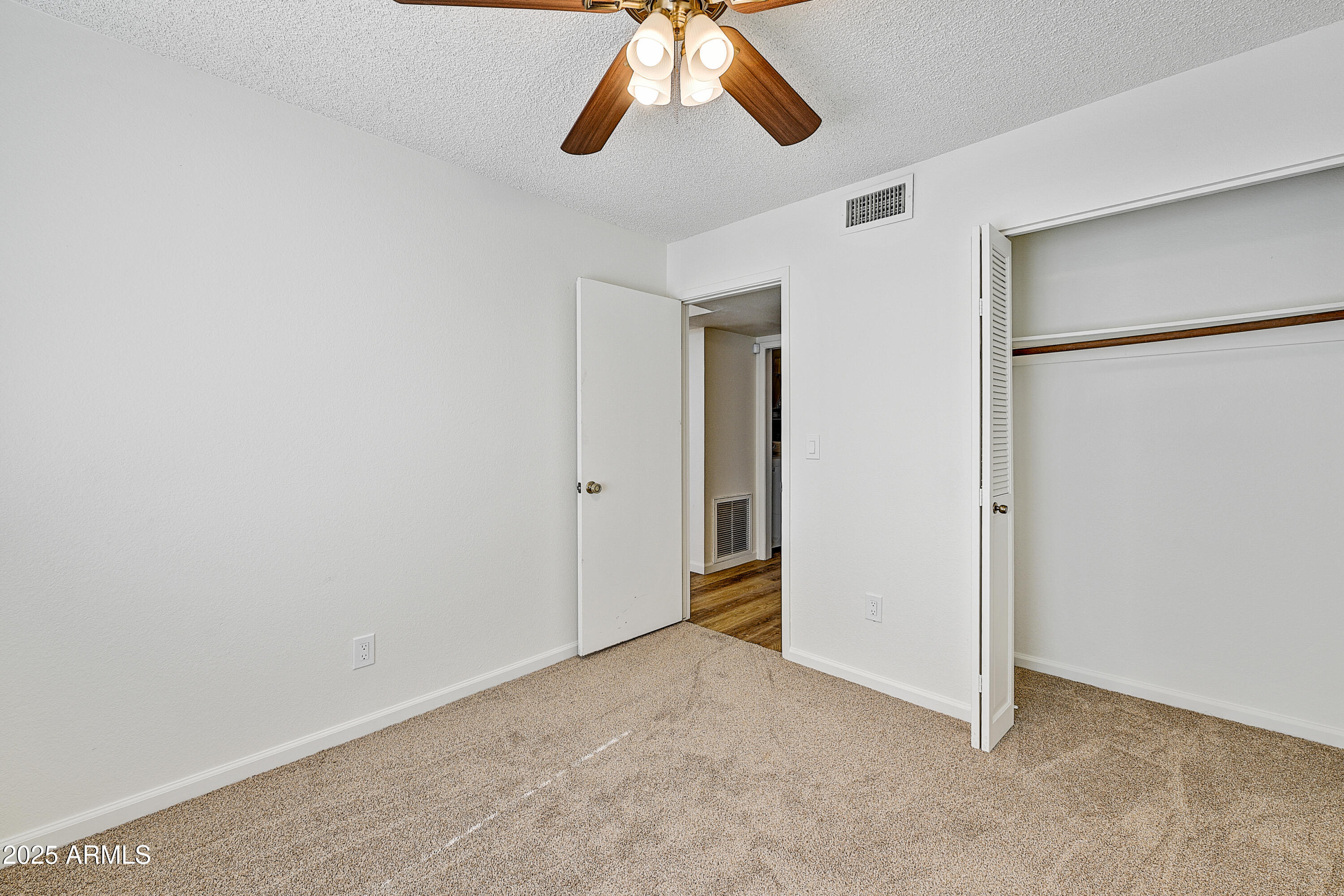 925 North College Avenue, Unit E217 Tempe, AZ 85288 - Photo 15 of 32 a view of a livingroom with a ceiling fan and window