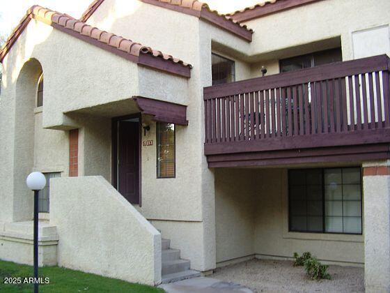 925 North College Avenue, Unit E217 Tempe, AZ 85288 - Photo 2 of 32 a view of a house with porch and wooden fence