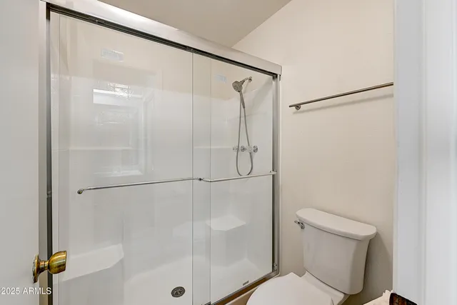 a bathroom with a shower and a toilet