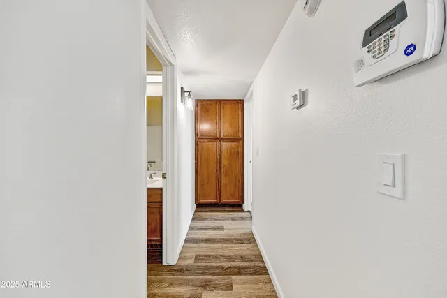a view of a hallway with wooden floor and staircase