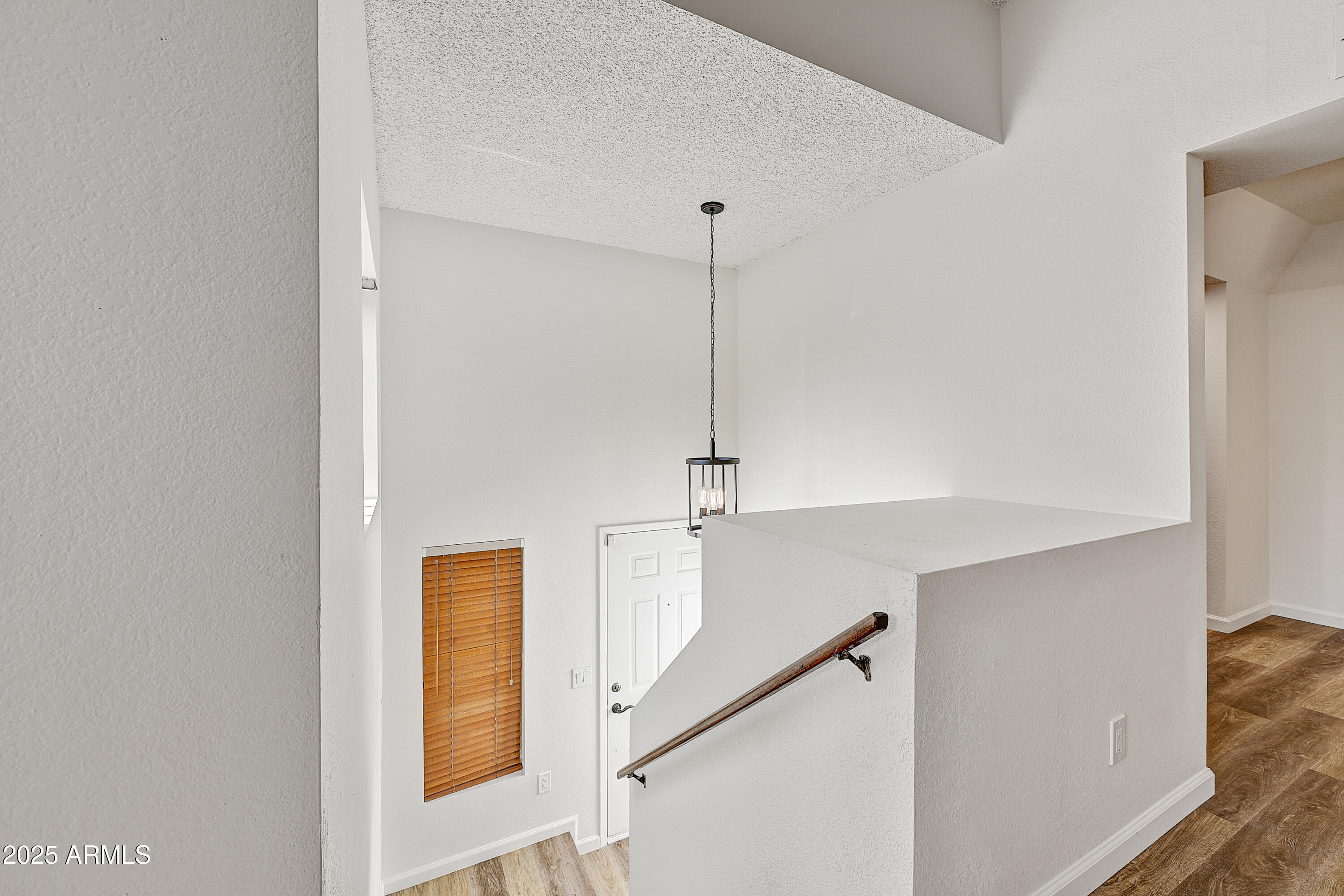 925 North College Avenue, Unit E217 Tempe, AZ 85288 - Photo 4 of 32 a view of an entryway with wooden floor