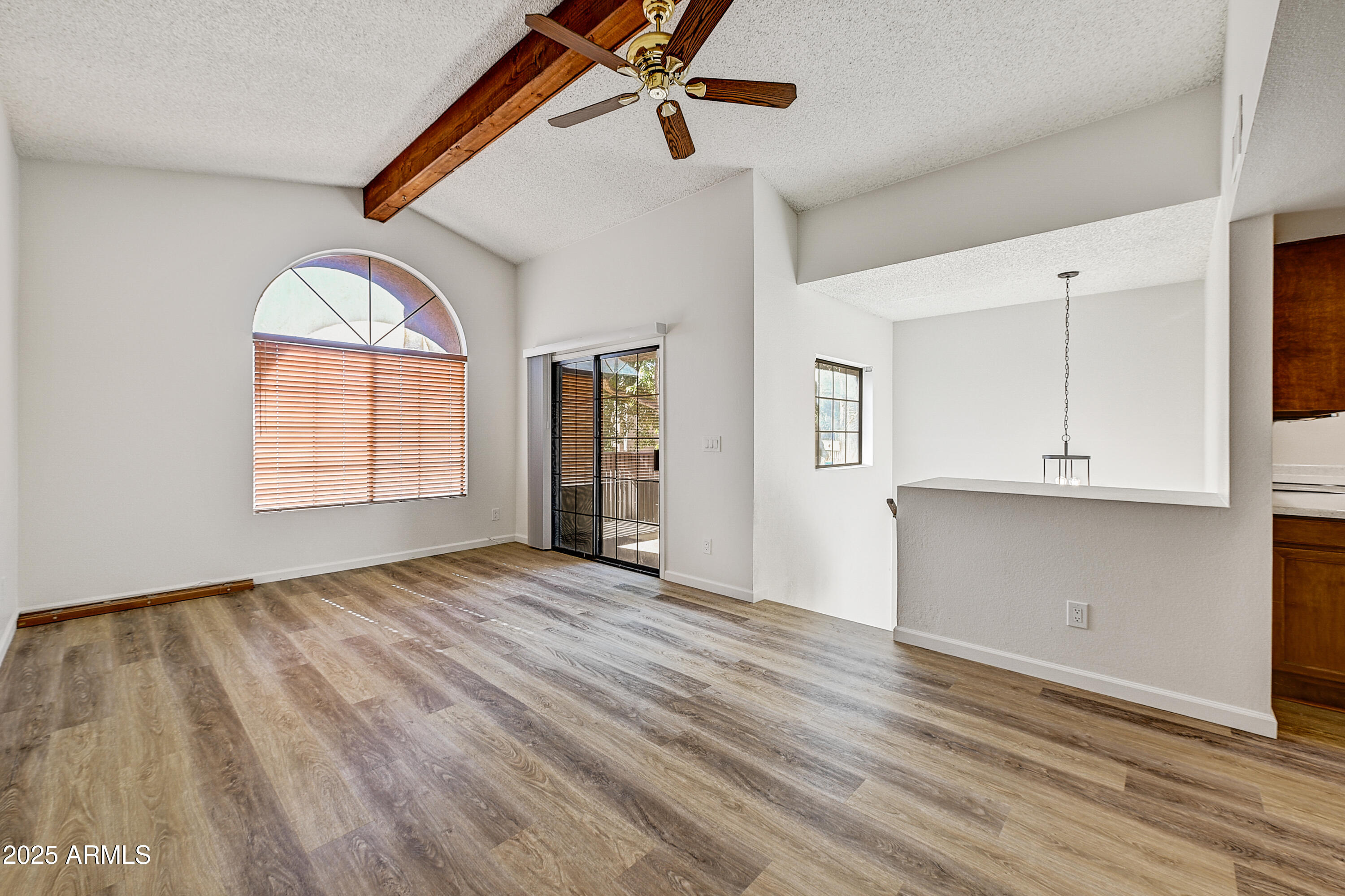925 North College Avenue, Unit E217 Tempe, AZ 85288 - Photo 5 of 32 a view of empty room with wooden floor and fan