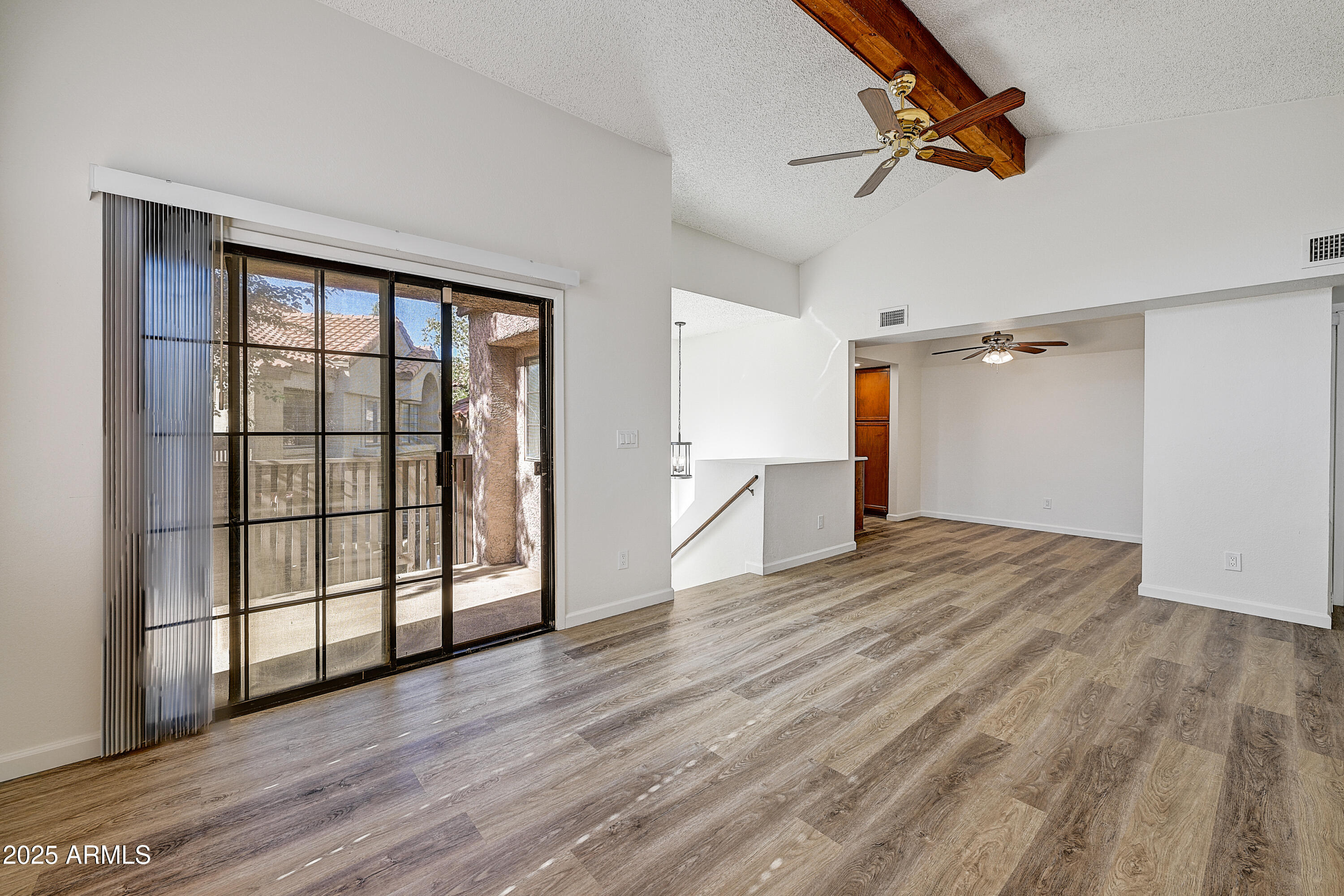 925 North College Avenue, Unit E217 Tempe, AZ 85288 - Photo 6 of 32 a view of empty room with wooden floor and fan