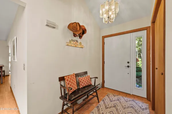a view of a hallway with entryway wooden floor and front door