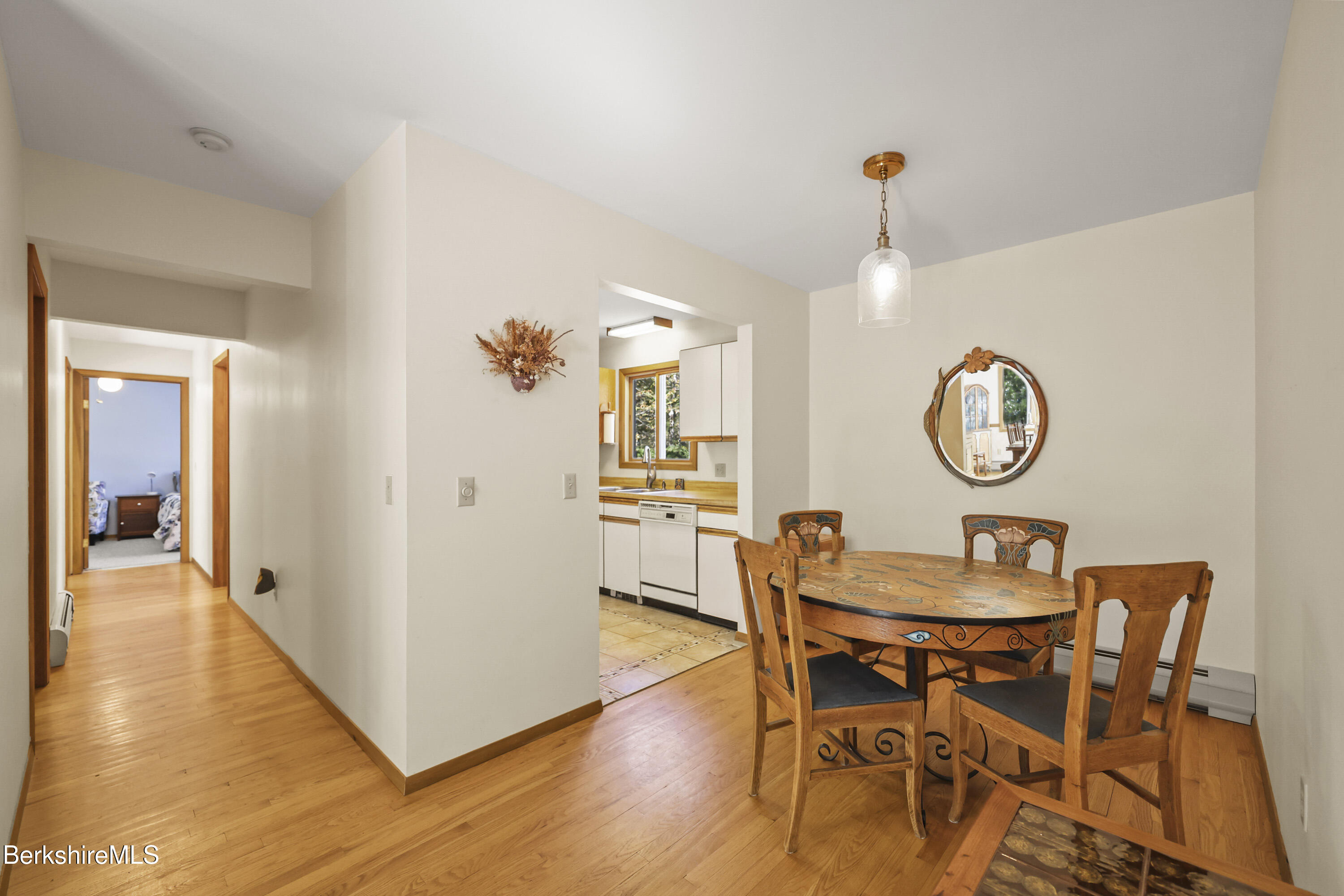 337 Captain Whitney Road Becket, MA 01223 - Photo 15 of 53 a view of a dining room with furniture and wooden floor