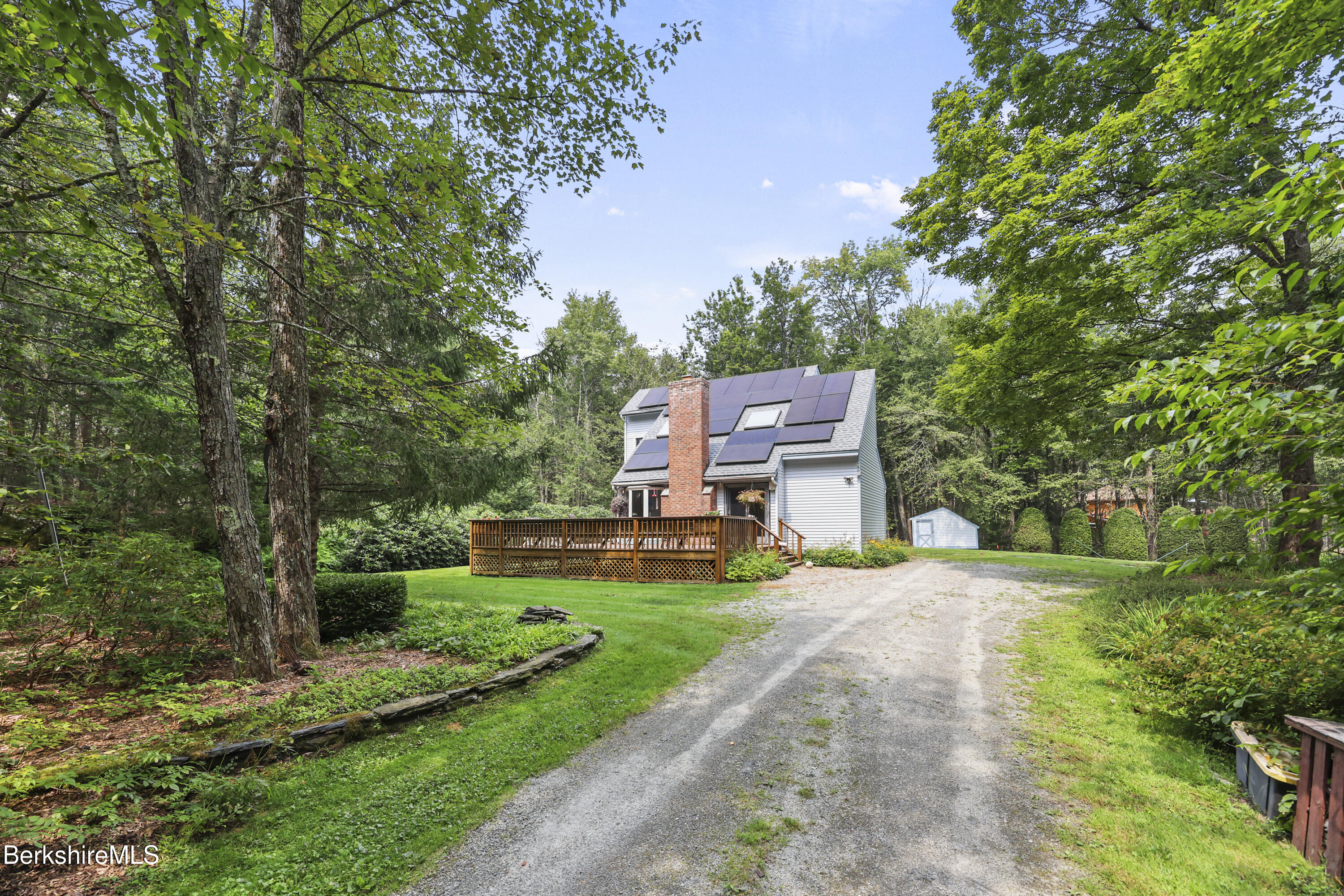 337 Captain Whitney Road Becket, MA 01223 - Photo 2 of 53 a view of a big house with a big yard plants and large trees