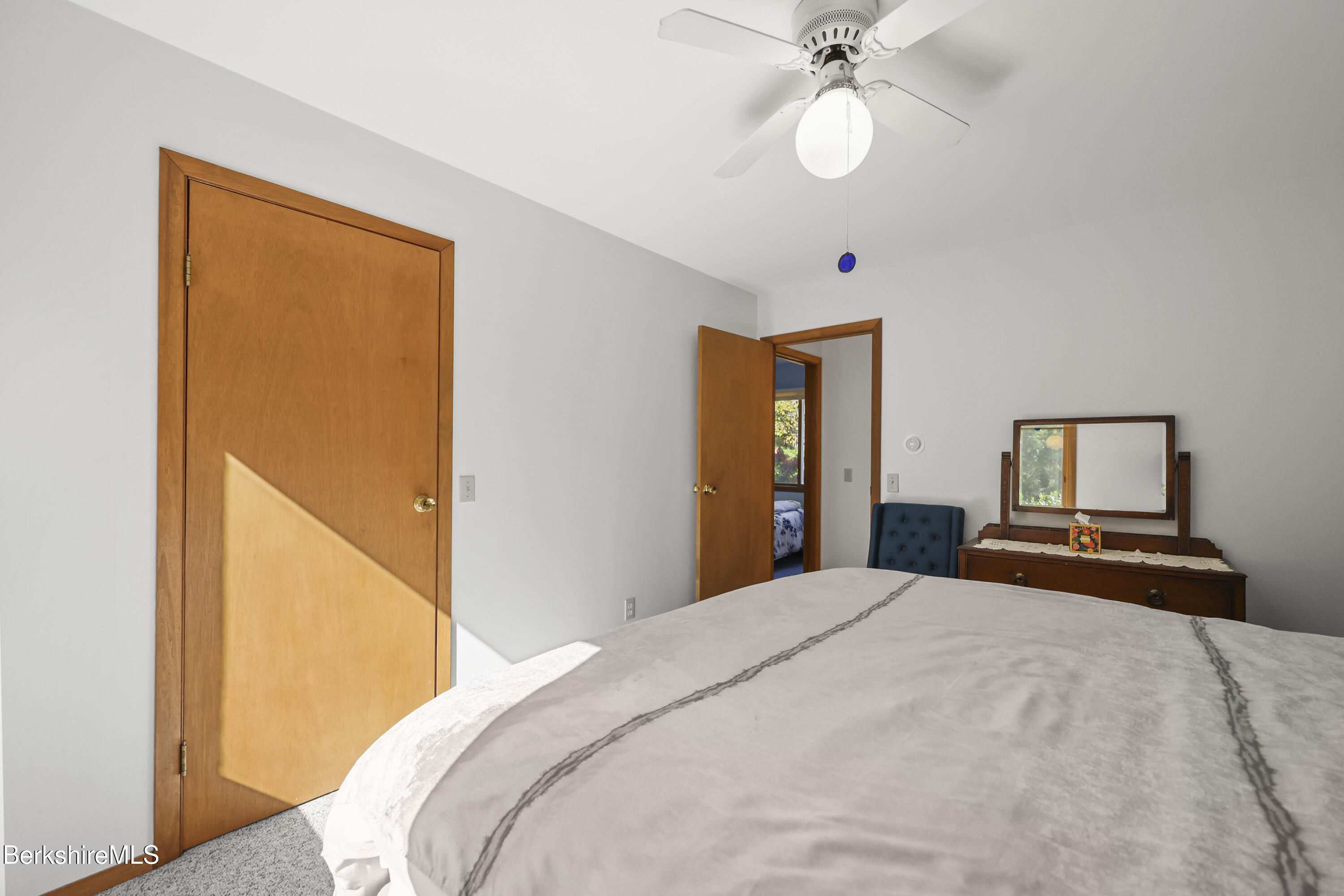 337 Captain Whitney Road Becket, MA 01223 - Photo 21 of 53 a bedroom with a bed and a chandelier