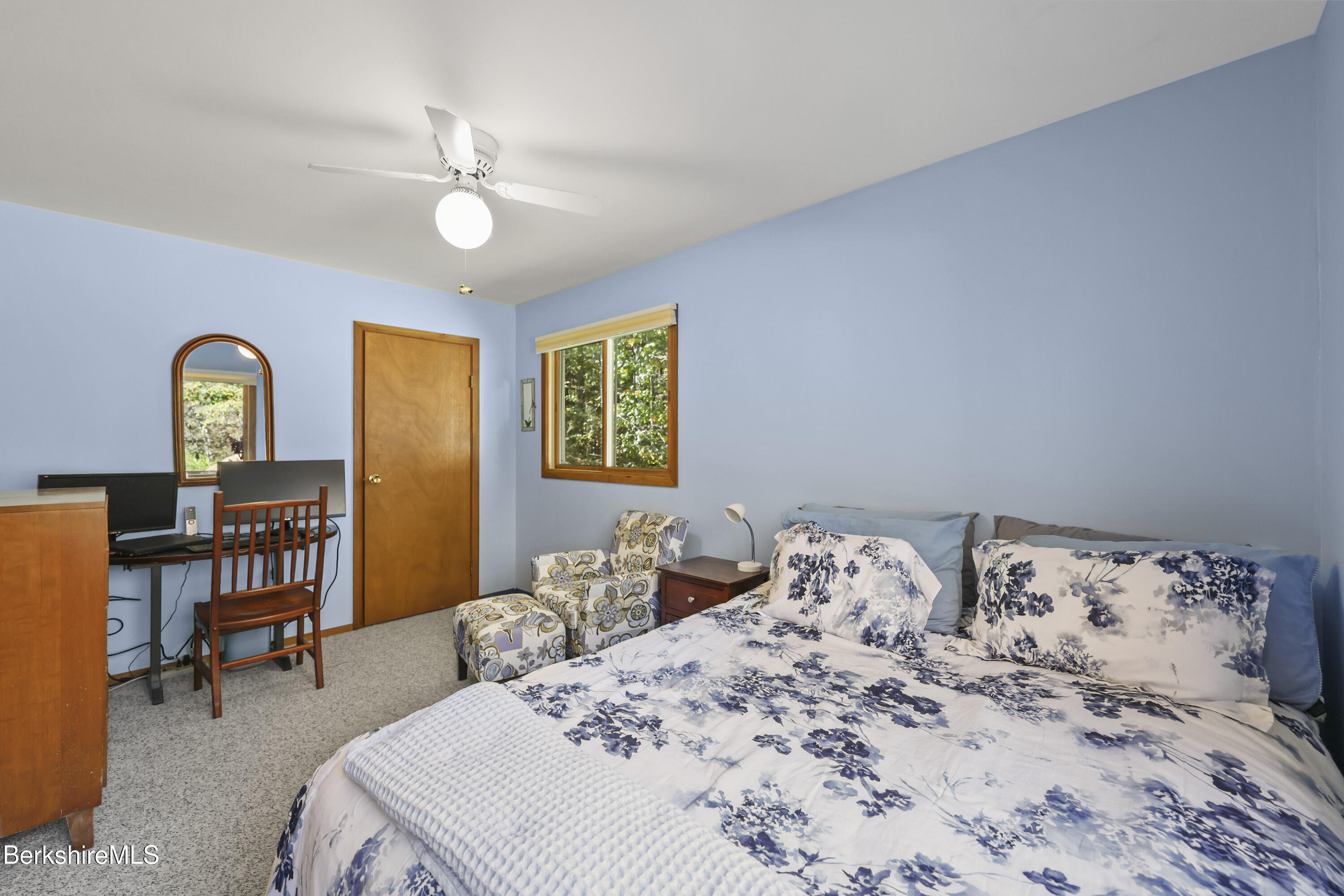 337 Captain Whitney Road Becket, MA 01223 - Photo 23 of 53 a bedroom with a bed table and chair