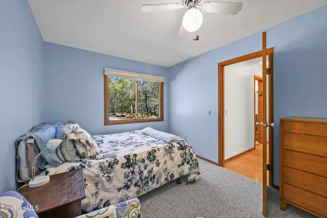 a bathroom with a granite countertop sink and a window