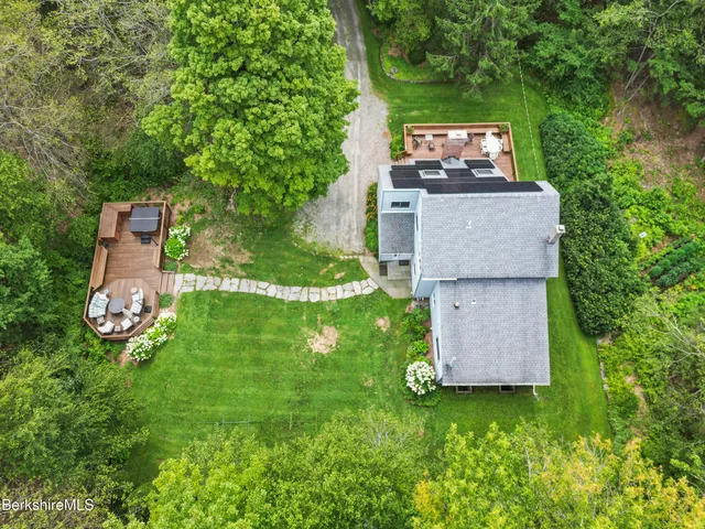 an aerial view of a house with a yard