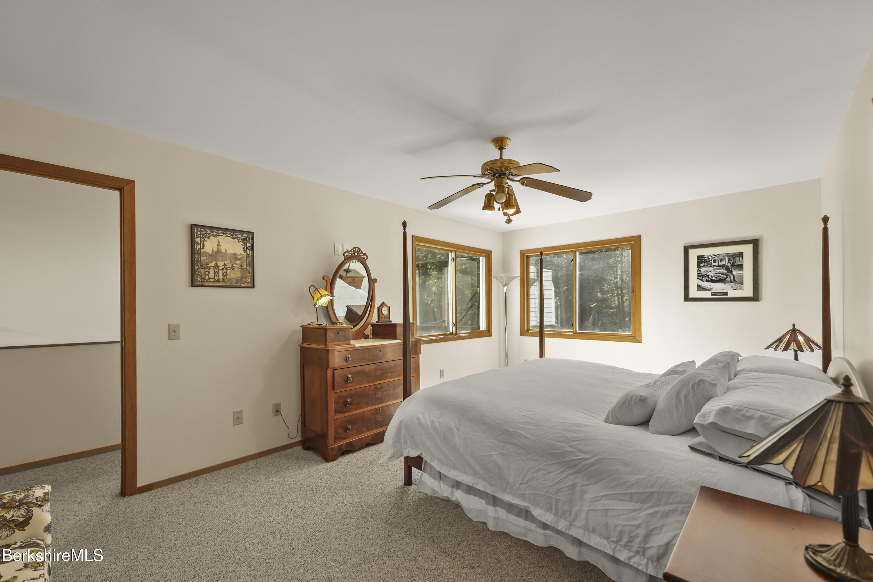 337 Captain Whitney Road Becket, MA 01223 - Photo 31 of 53 a spacious bedroom with a bed and a chandelier