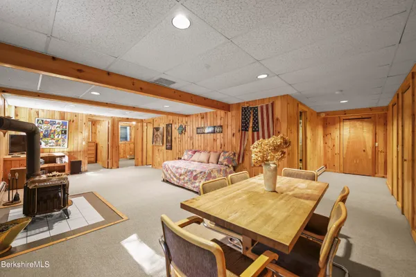 a spacious bedroom with a large bed and a flat tv screen