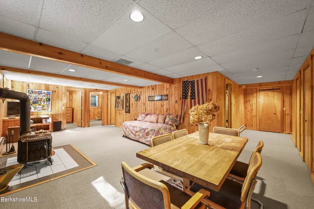 a spacious bedroom with a large bed and a flat tv screen