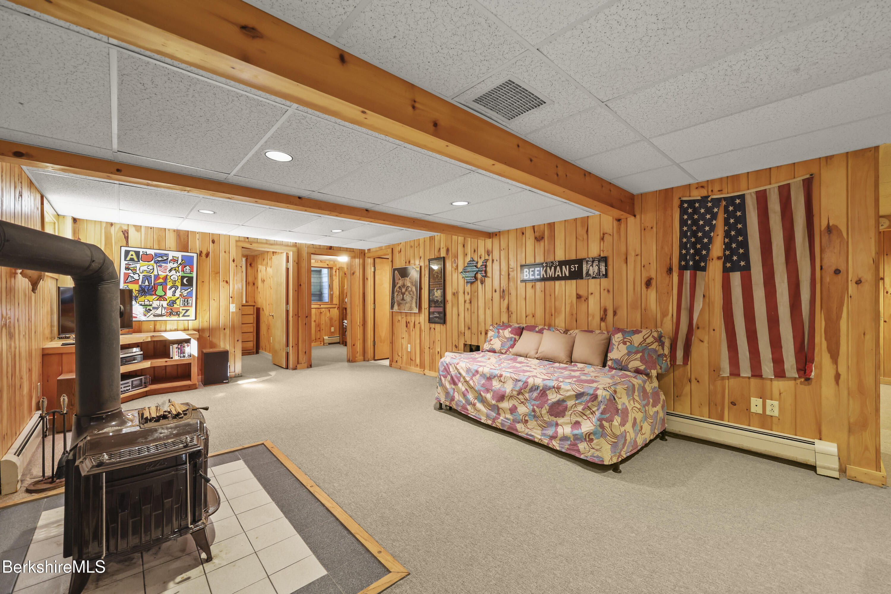 337 Captain Whitney Road Becket, MA 01223 - Photo 37 of 53 a spacious bedroom with a large bed and a flat tv screen