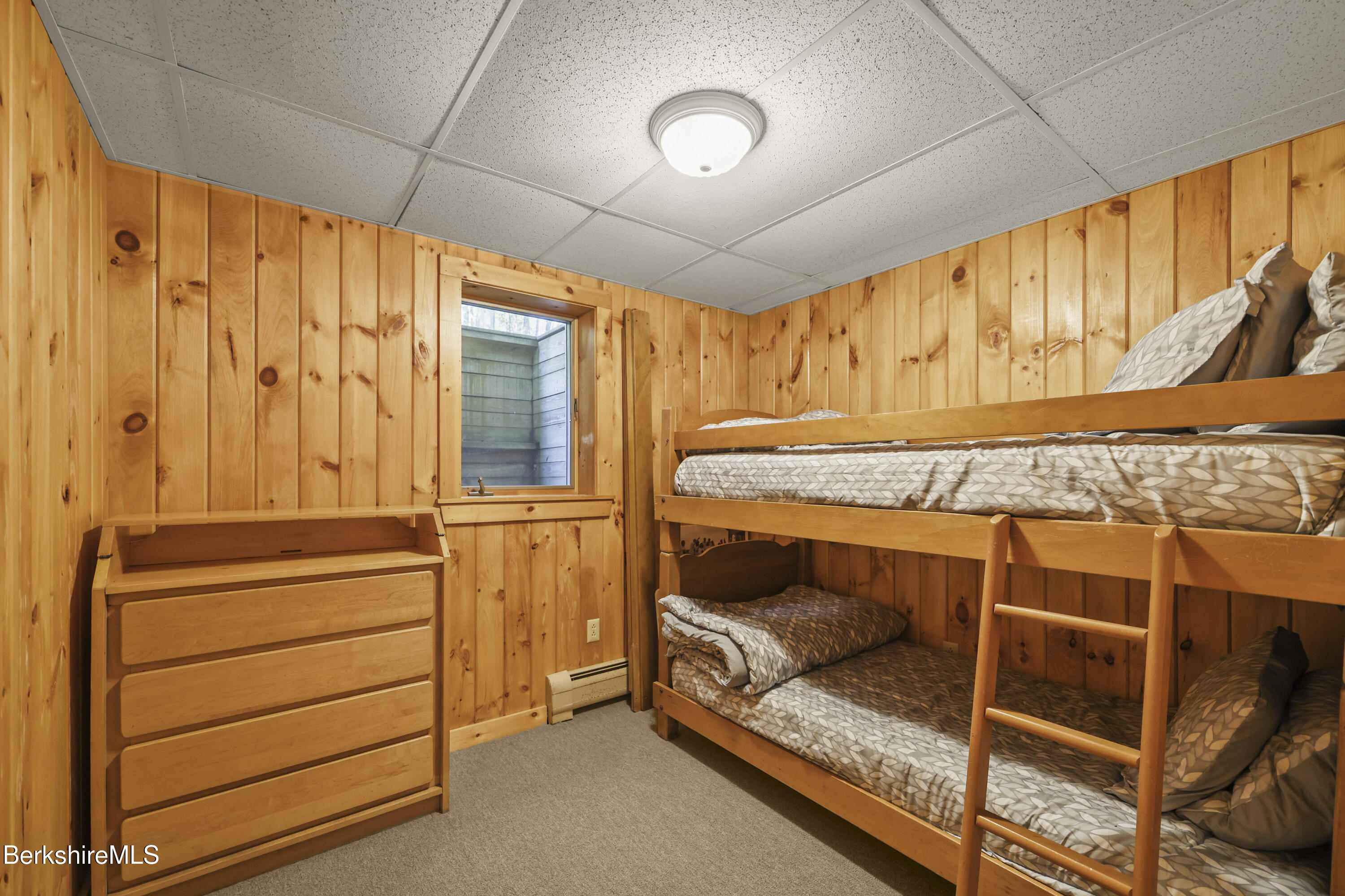 337 Captain Whitney Road Becket, MA 01223 - Photo 40 of 53 a bedroom with a bed and a window