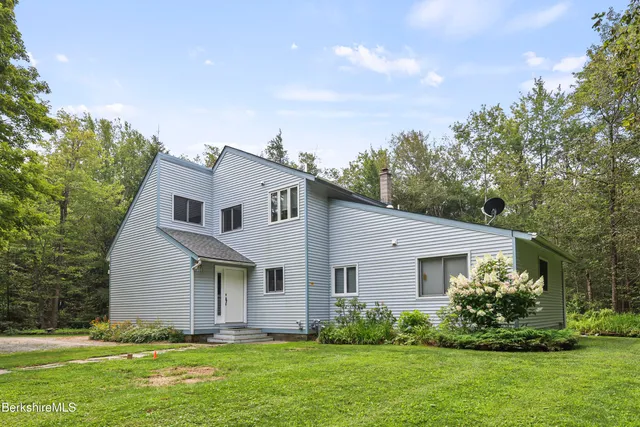a view of a balcony with chairs and wooden floor