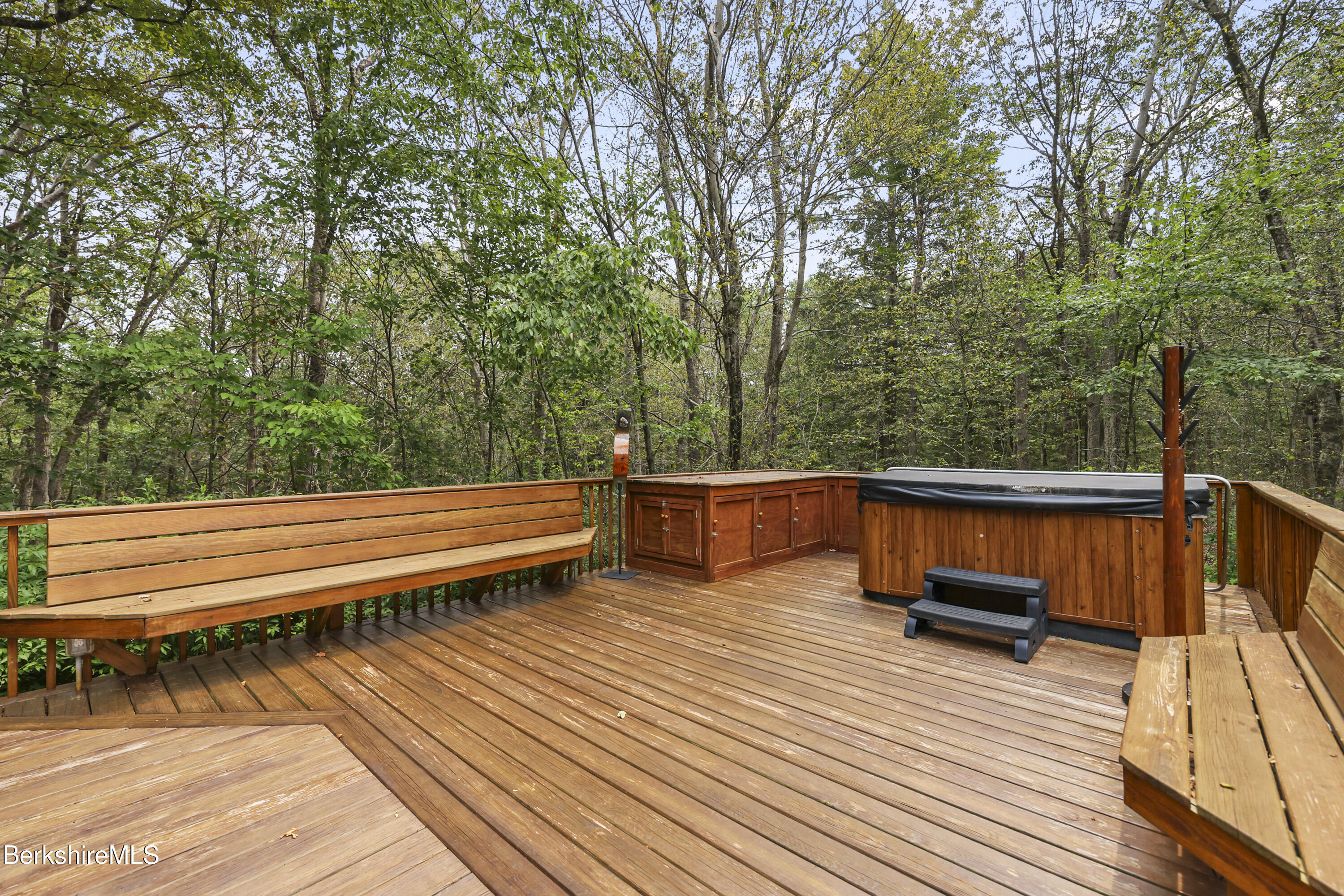 337 Captain Whitney Road Becket, MA 01223 - Photo 47 of 53 a view of a balcony with chairs and wooden floor