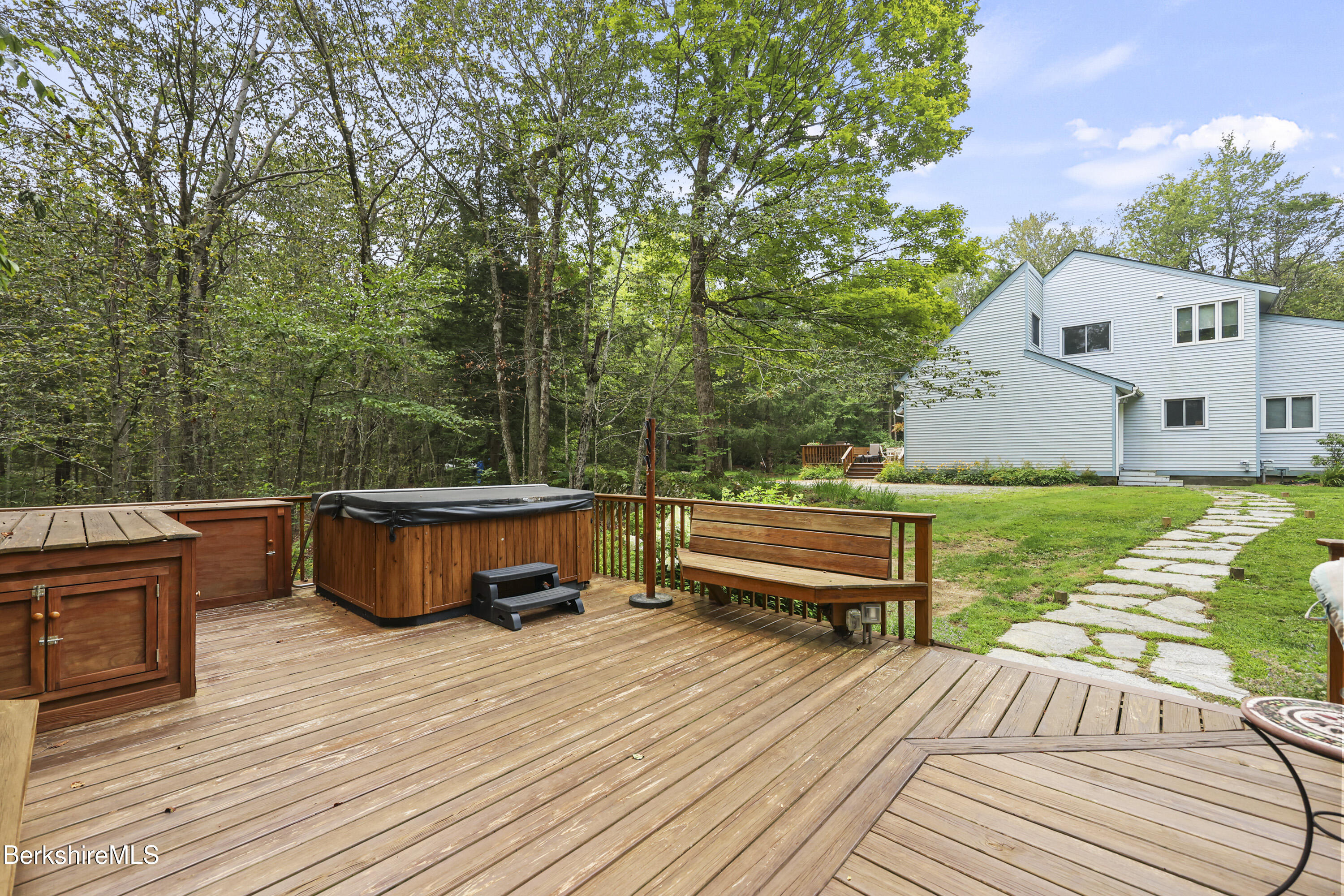 337 Captain Whitney Road Becket, MA 01223 - Photo 48 of 53 a view of a deck with two chairs and a table