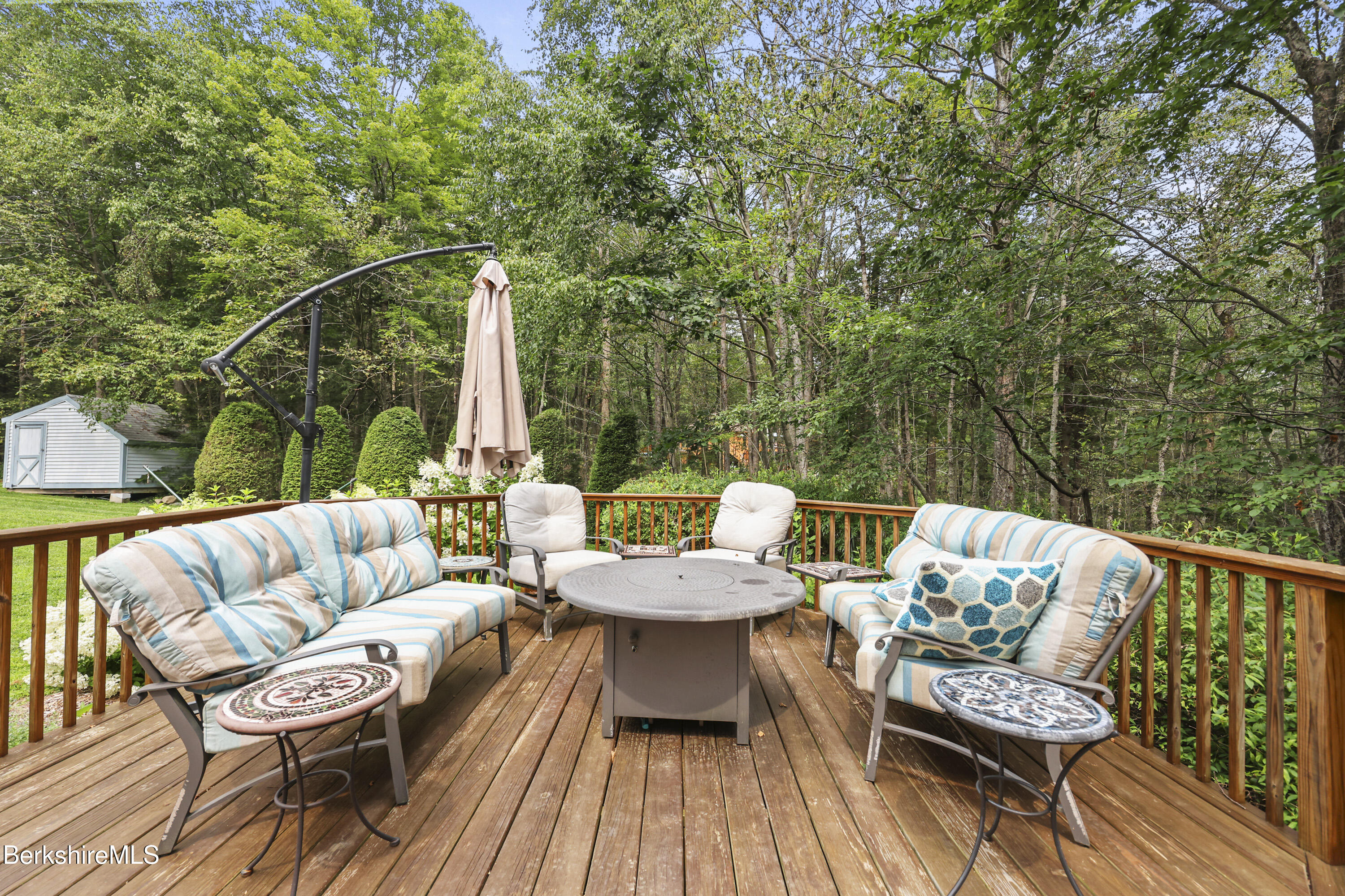 337 Captain Whitney Road Becket, MA 01223 - Photo 50 of 53 a view of a patio with couches and a potted plant on a table with wooden floor