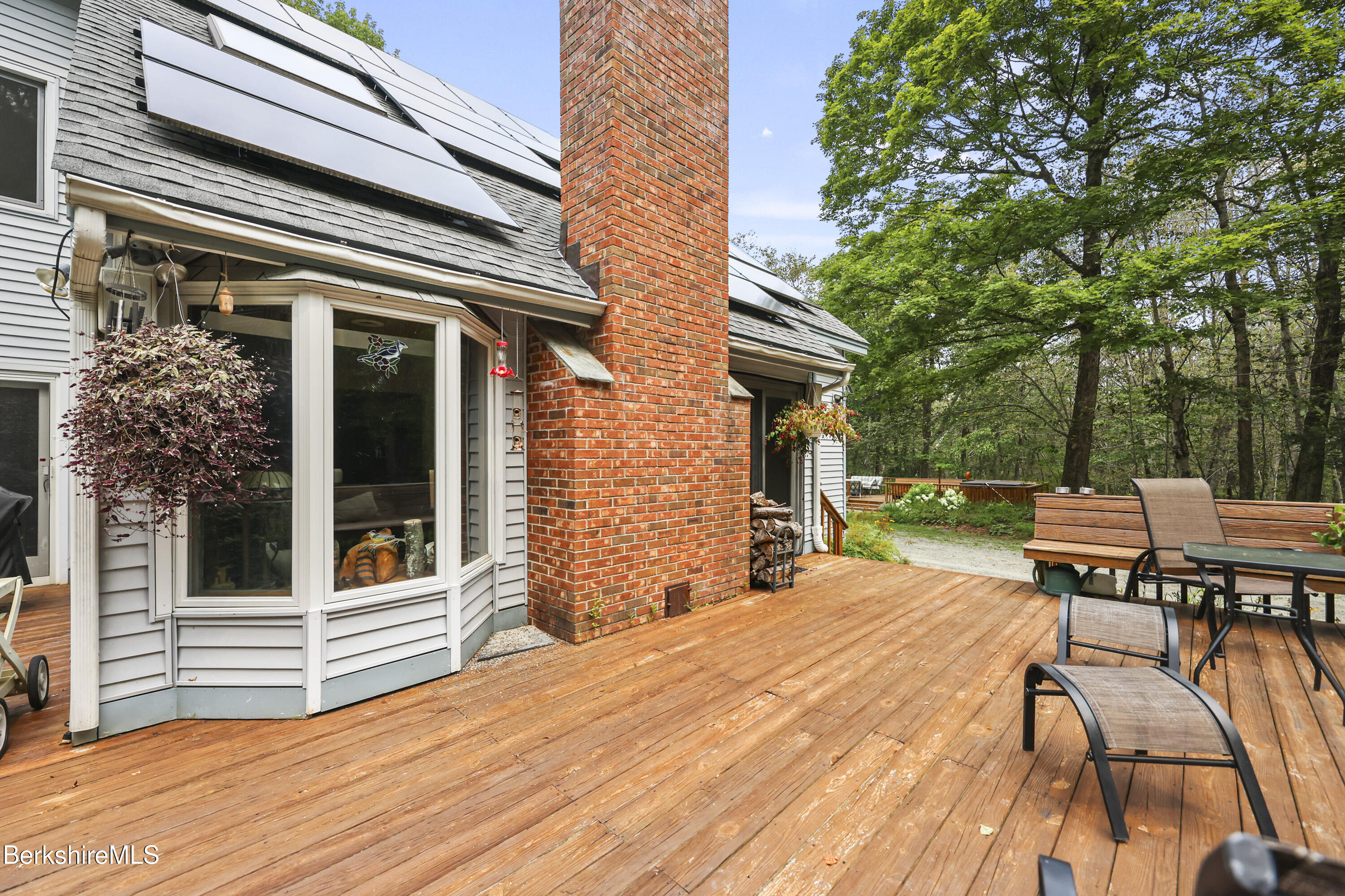 337 Captain Whitney Road Becket, MA 01223 - Photo 5 of 53 a view of a patio with table and chairs and floor to ceiling window