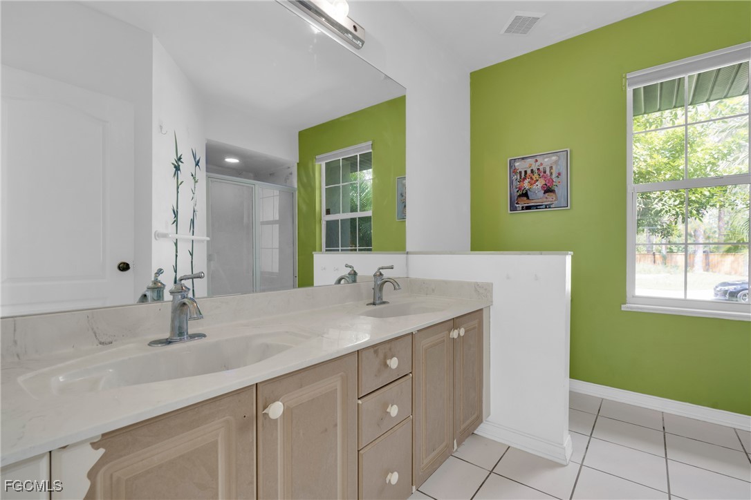 809 Hamilton Avenue Lehigh Acres, FL 33972 - Photo 14 of 25 a bathroom with a sink and a mirror