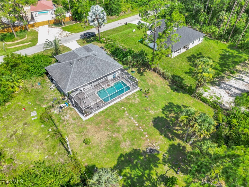 809 Hamilton Avenue Lehigh Acres, FL 33972 - Photo 25 of 25 an aerial view of a house with swimming pool and garden