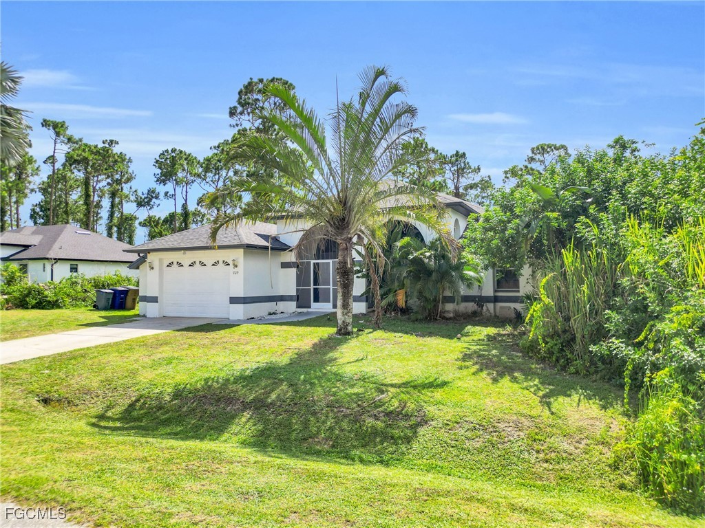 809 Hamilton Avenue Lehigh Acres, FL 33972 - Photo 3 of 25 a house with swimming pool in front of it