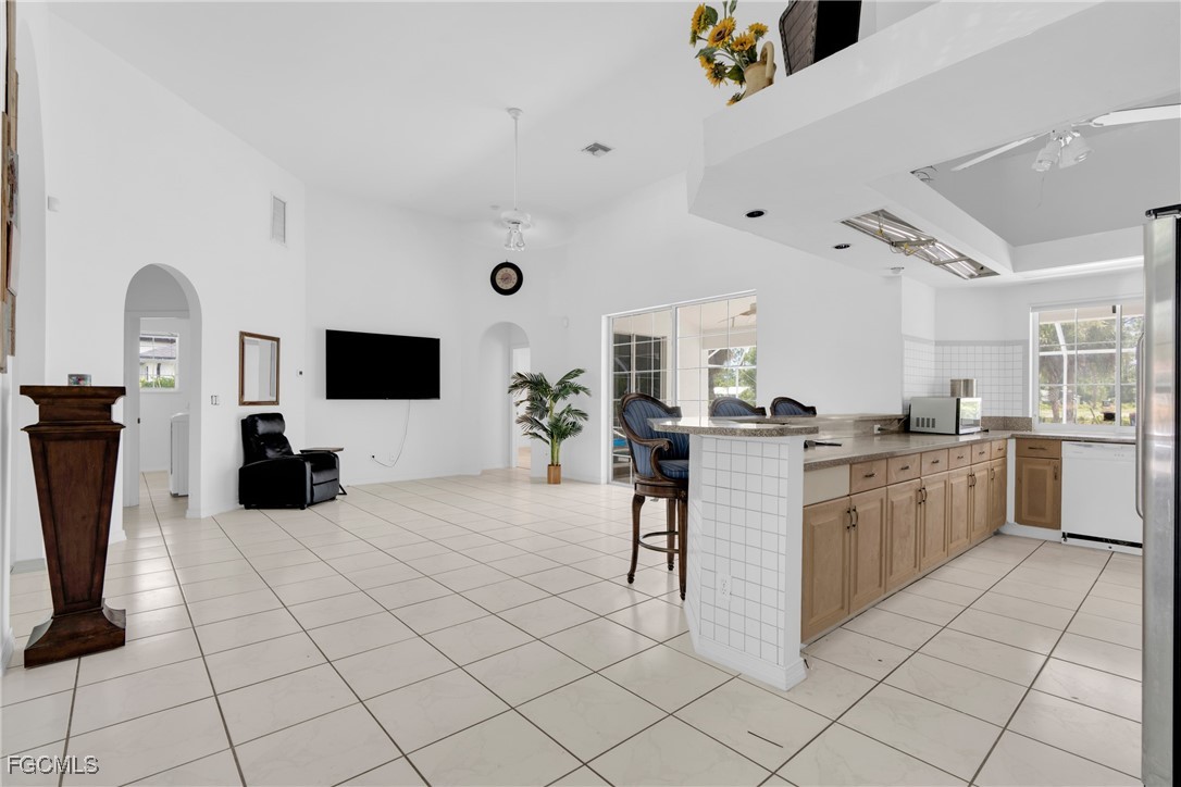 809 Hamilton Avenue Lehigh Acres, FL 33972 - Photo 6 of 25 a kitchen with cabinets and chairs in it
