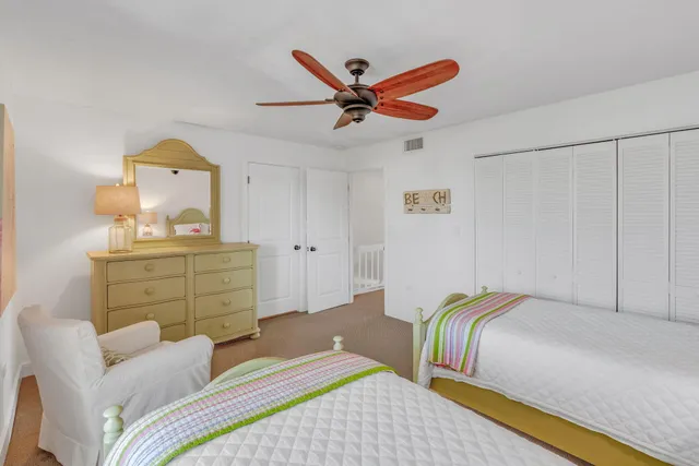 a bathroom with a granite countertop sink mirror vanity and toilet