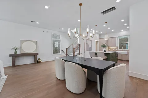 a kitchen with kitchen island a counter top space a sink stainless steel appliances and cabinets
