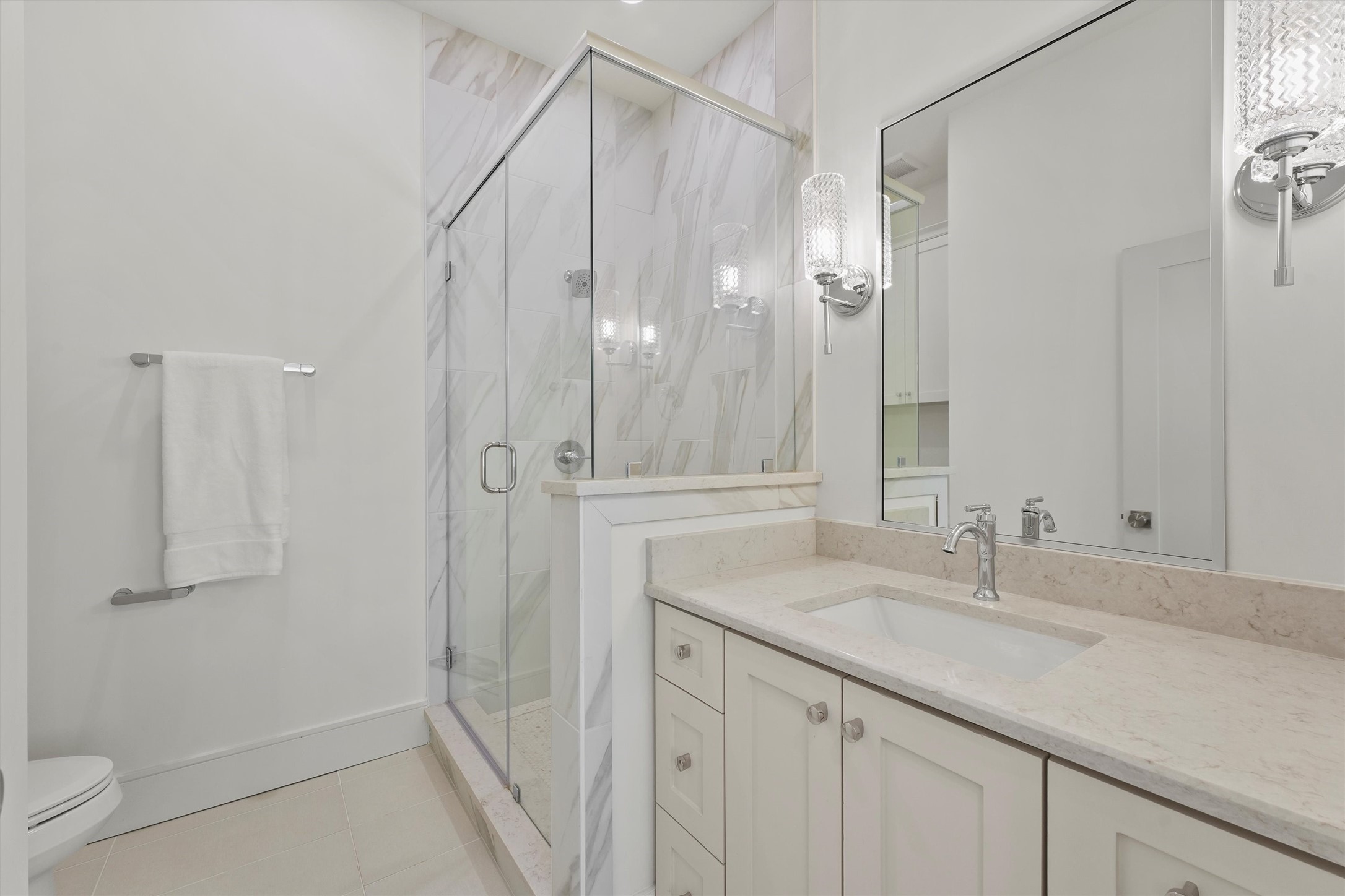 5407 Dickson Street Houston, TX 77007 - Photo 20 of 31 a bathroom with a granite countertop sink a mirror and a shower